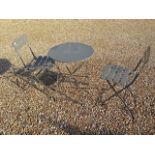 A grey metal folding patio/bistro table and two chairs
