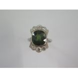 An 18ct white gold and platinum diamond and green stone ring size M - head 19mm x 13mm - diamonds