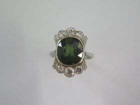 An 18ct white gold and platinum diamond and green stone ring size M - head 19mm x 13mm - diamonds