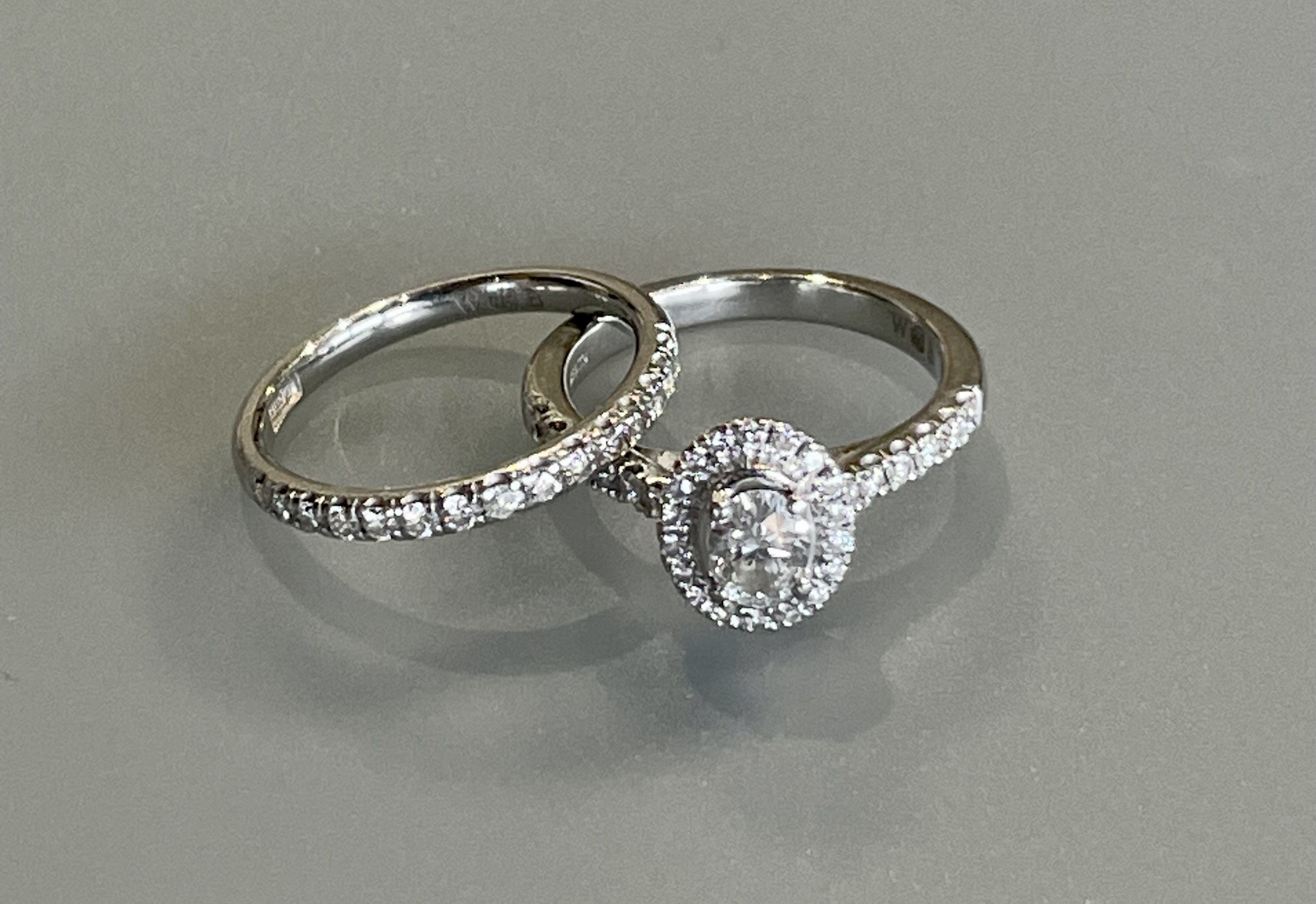 A platinum and diamond cluster ring with a central 0.32ct diamond - Colour F, Clarity VS - ring size