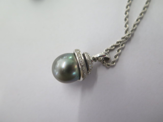 A white metal diamond set tear drop black pearl pendant on an 18ct white gold 42cm chain along - Image 5 of 5