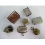 Three base metal coin cases, a plated vesta, a Rams head vesta and a plated matchbox case and