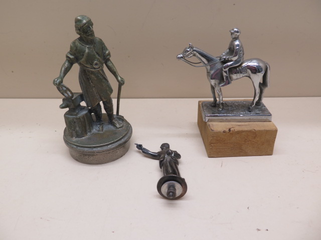 Three figural car mascots - Dart player, Jockey and horse and Blacksmith - Height 14cm