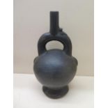 A Pre-Columbian or later black ware pottery stirrup pot with bird detail, crack to base, possible