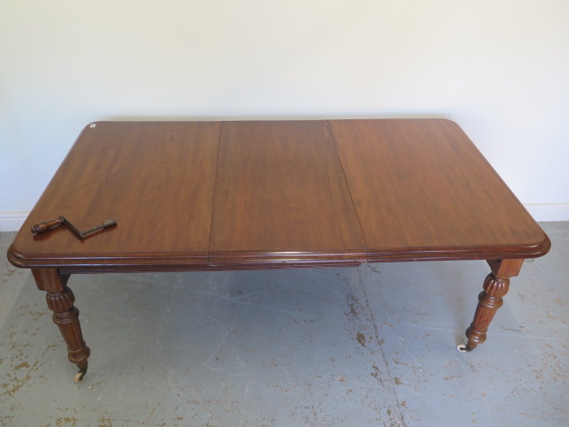 A Victorian mahogany windout dining table with one leaf on turned fluted legs - Height 73cm x - Image 2 of 3
