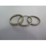 An 18ct white gold band ring size M - approx weight 1.8 grams - and two white metal eternity rings