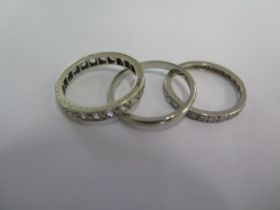 An 18ct white gold band ring size M - approx weight 1.8 grams - and two white metal eternity rings