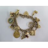 A 9ct yellow gold charm bracelet with an Edward VII gold half sovereign dated 1909 with 13