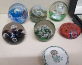A collection of seven paperweights