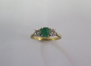 A hallmarked 18ct yellow gold diamond and emerald three stone ring size M/N - approx weight 2.8