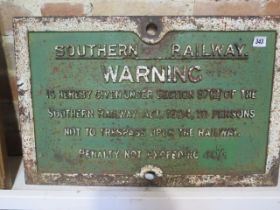 A cast iron original green and white 'Southern Railway Warning Trespassing' sign, in as removed