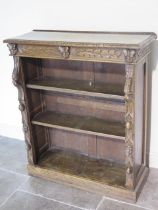 A carved oak open bookcase - Height 105cm x 90cm x 33cm