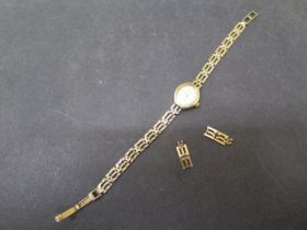A 9ct gold ladies Accurist wristwatch - weight 11 grams - with box and two spare links