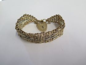 A 9ct yellow and white gold bracelet - 21mm wide - hallmarked London 1973 S&K - approx weight 42