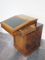 A 19th century rosewood davenport desk with a sliding top above a slide and four drawers - Height