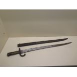 A 19th century bayonet/sword with a curved blade - Total length 69cm with scabbard, some rusting and