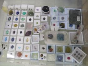 A large collection of loose gem stones including opals, quartz, citrine, tourmaline - with painted