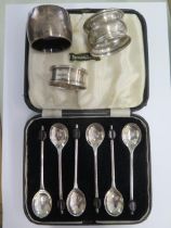 Three silver napkin rings and a boxed set of six silver coffee bean spoons - Sheffield 1939 E
