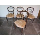 A set of four Victorian walnut balloon back dining chairs