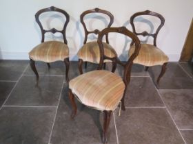 A set of four Victorian walnut balloon back dining chairs