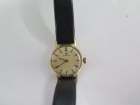 A 9ct yellow gold manual wind ladies wristwatch 18mm case on a leather strap