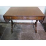 A 19th century mahogany drop leaf stretcher table with two active and two dummy drawers on twin