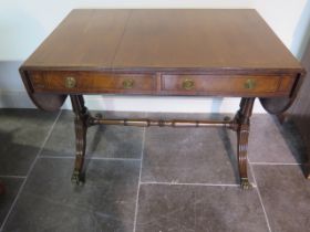 A 19th century mahogany drop leaf stretcher table with two active and two dummy drawers on twin