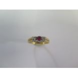 A hallmarked 18ct yellow gold diamond and ruby three stone ring size N - approx weight 3.4 grams -