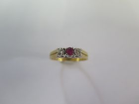 A hallmarked 18ct yellow gold diamond and ruby three stone ring size N - approx weight 3.4 grams -