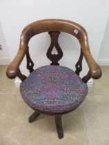 A Victorian mahogany swivel desk chair with inverted heart motifs - Height 88cm x Width 58cm with