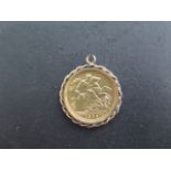 An Edward VII gold full sovereign dated 1906 in a gilt metal mount - loop worn - approx total weight