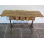 A walnut three drawer dropleaf stretcher table with a shaped top - Height 73cm x 197cm x 55cm