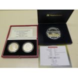 A silver proof 5oz Flying Scotsman coin and two Prince Ander silver Piedfort 50 pence coins -