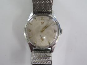 An Omega manual wind gents wristwatch with 34mm case on a sprung strap - running, dial worn, some