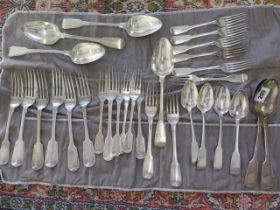 A collection of silver flatware forks and spoons including six matching forks and six matching