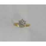 An 18ct yellow gold diamond cluster ring size J/K - approx weight 4 grams - good condition