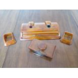 A Carvacraft amber resin four piece desk set with pencil - in good condition