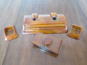 A Carvacraft amber resin four piece desk set with pencil - in good condition