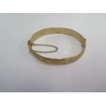 A hallmarked 9ct yellow gold hinged bangle - 6.5cm x 5.5cm external - approx weight 24.7 grams -