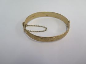 A hallmarked 9ct yellow gold hinged bangle - 6.5cm x 5.5cm external - approx weight 24.7 grams -