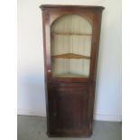 A Georgian oak two part corner cupboard with a base door and painted interior - Height 184cm x Width