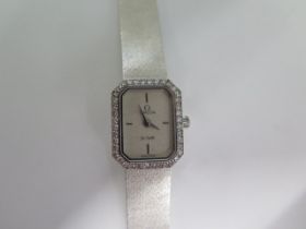 An 18ct white gold ladies Omega De Ville quartz watch with diamond bezel - new battery fitted