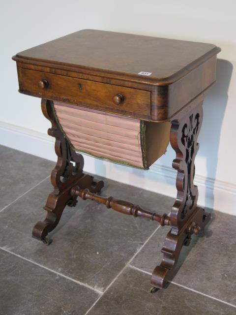 A Victorian burr walnut workbox with a fitted drawer and basket on shaped fretted supports united by