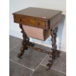 A Victorian burr walnut workbox with a fitted drawer and basket on shaped fretted supports united by