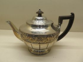 A silver teapot with embossed design London 1893/94 - armorial engraving - approx weight 20.1 troy