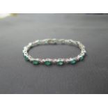 A stunning emerald diamond and 18ct white gold bracelet (unmarked but tested) - seventeen oval