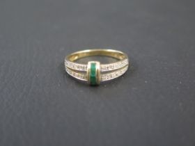 A 9ct yellow gold ring with emeralds - ring size P - weight approx 2.1 grams