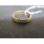 An 18ct bi colour gold and CZ eternity ring size O - weight approx 4.4 grams