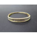 A 14ct yellow gold bracelet with diamonds set in two rows - approx 6cm width - weight approx 16.3