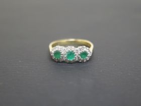 An 18ct yellow gold emerald and diamond ring size O - weight approx 3.1 grams